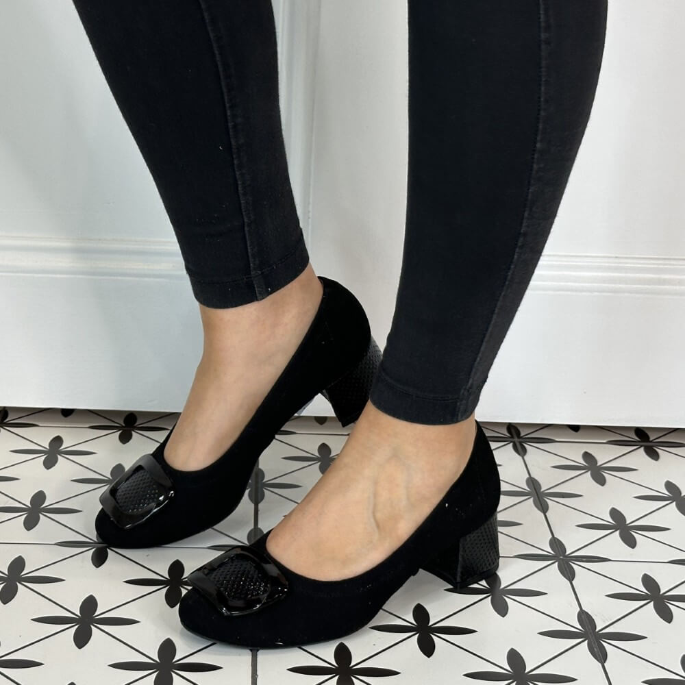 Black shoes with buckles worn by a person on a patterned floor. Bioeco 6883 H Fit Block Heel Black Suede
