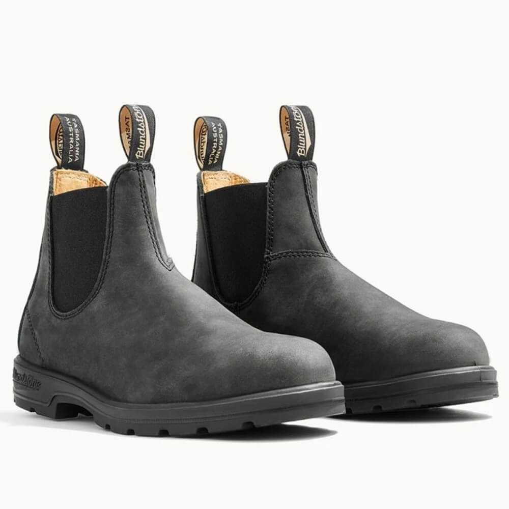 Pair of black Chelsea boots with Blundstone branding on a white background