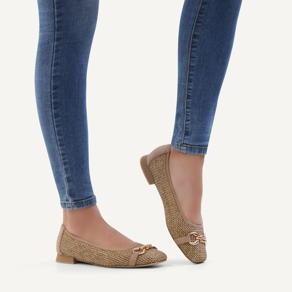 Caprice Beige woven flats worn with Blue jeans on a white background