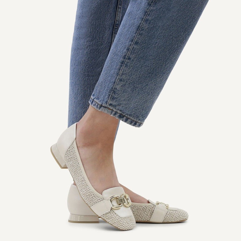 Caprice White textured flats worn with blue jeans on a white background