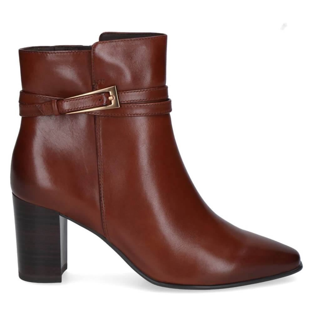 A Caprice cognac leather ankle boot with a block heel, pointed toe, and a decorative strap with a gold-tone buckle detail around the ankle.