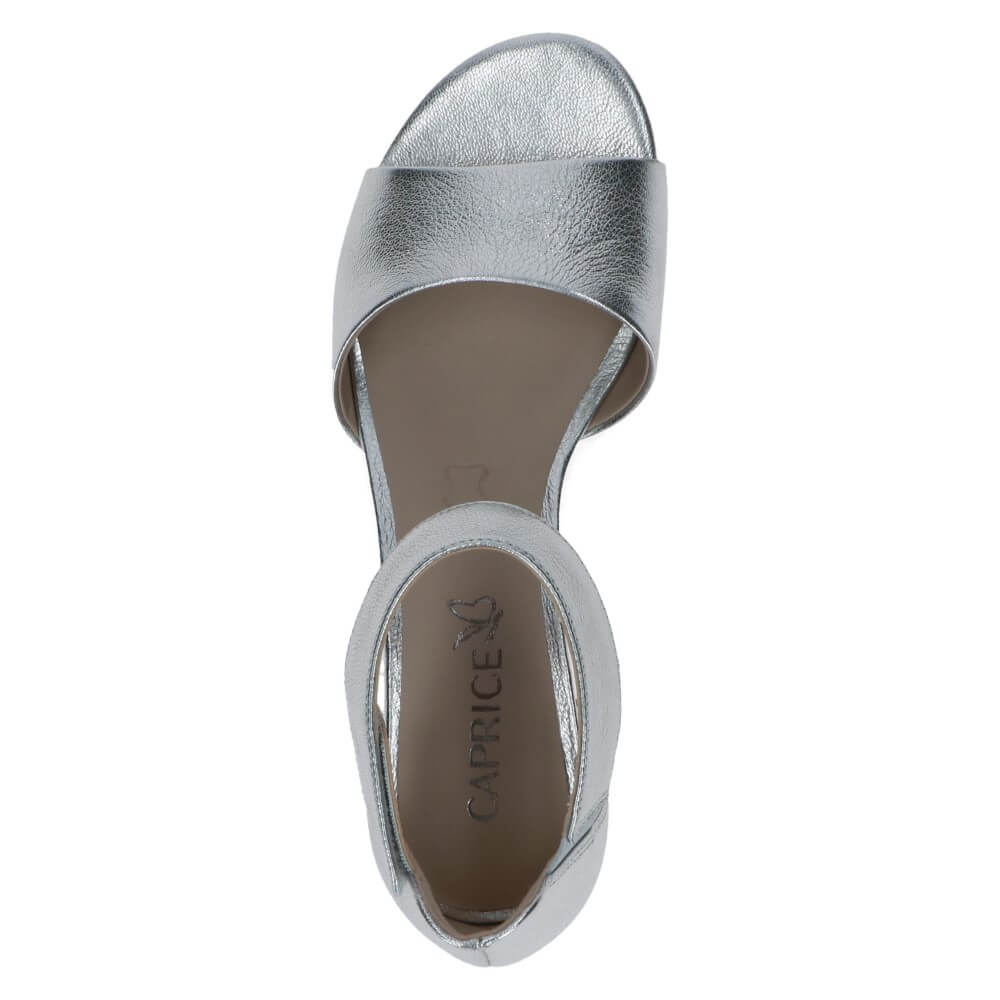 Silver high-heeled sandal with 'Caprice' branding on a white background
