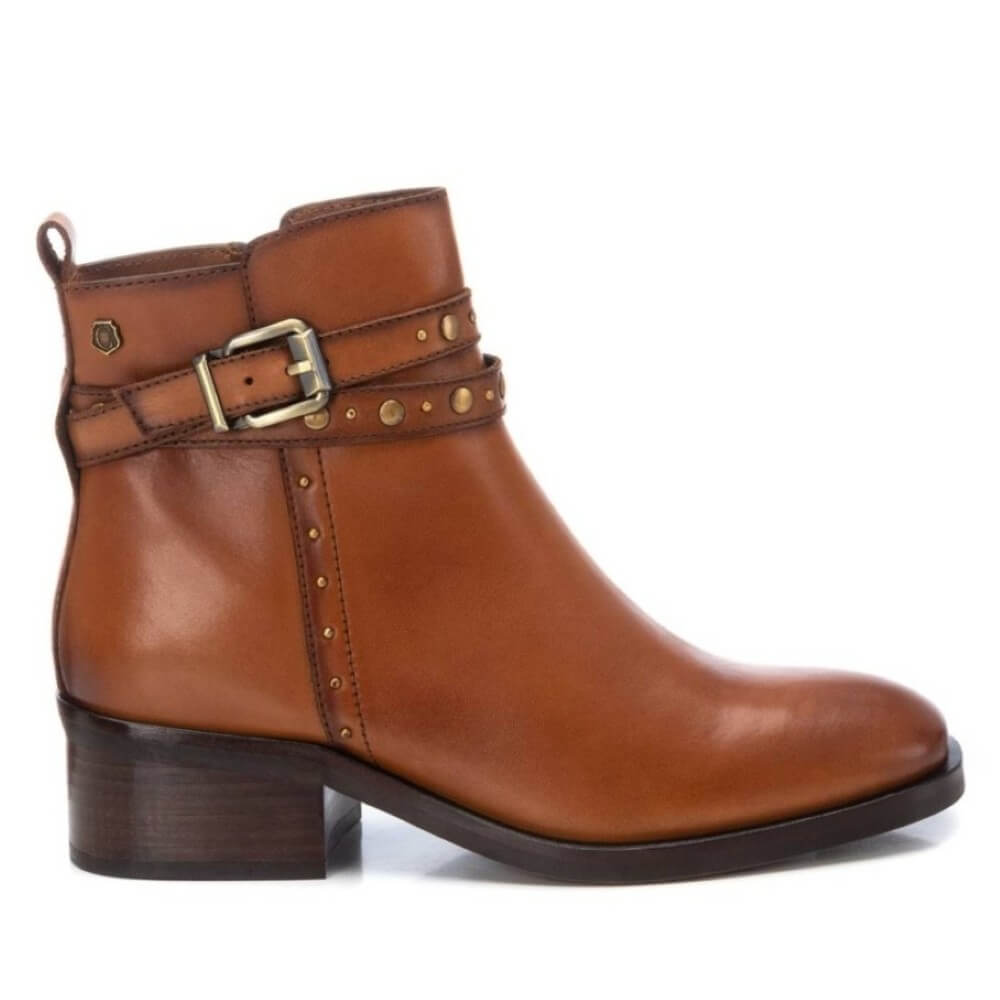 Brown leather boot with a buckle on a white background