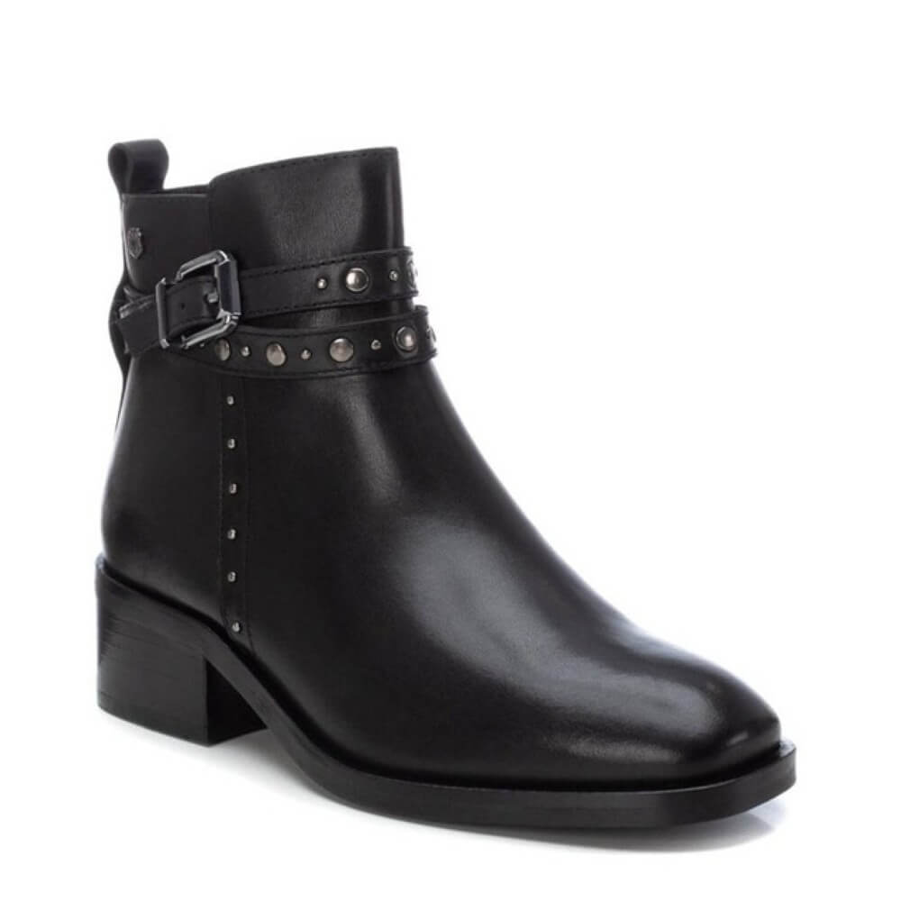 Black leather ankle boot with studded details on a white background
