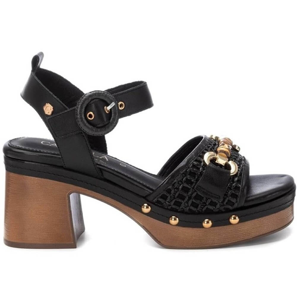 Carmela Black sandal with wooden effect platform and gold accents on a white background