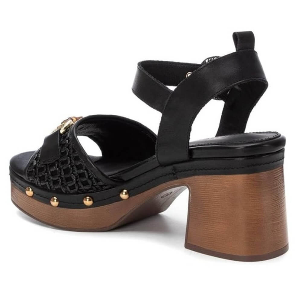 Carmela Black sandal with wooden effect platform and gold accents on a white background
