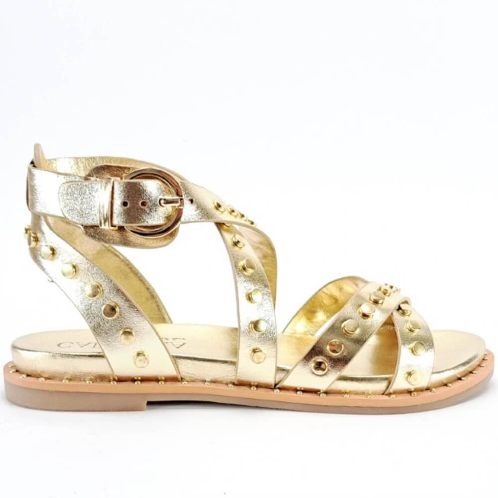 Carmela Gold Gladiator sandal with studded details on a white background
