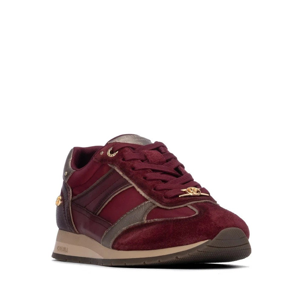 A single low-top sneaker in burgundy suede and leather with gray accents, brown sole details, and gold-tone hardware, shown on a plain white background.