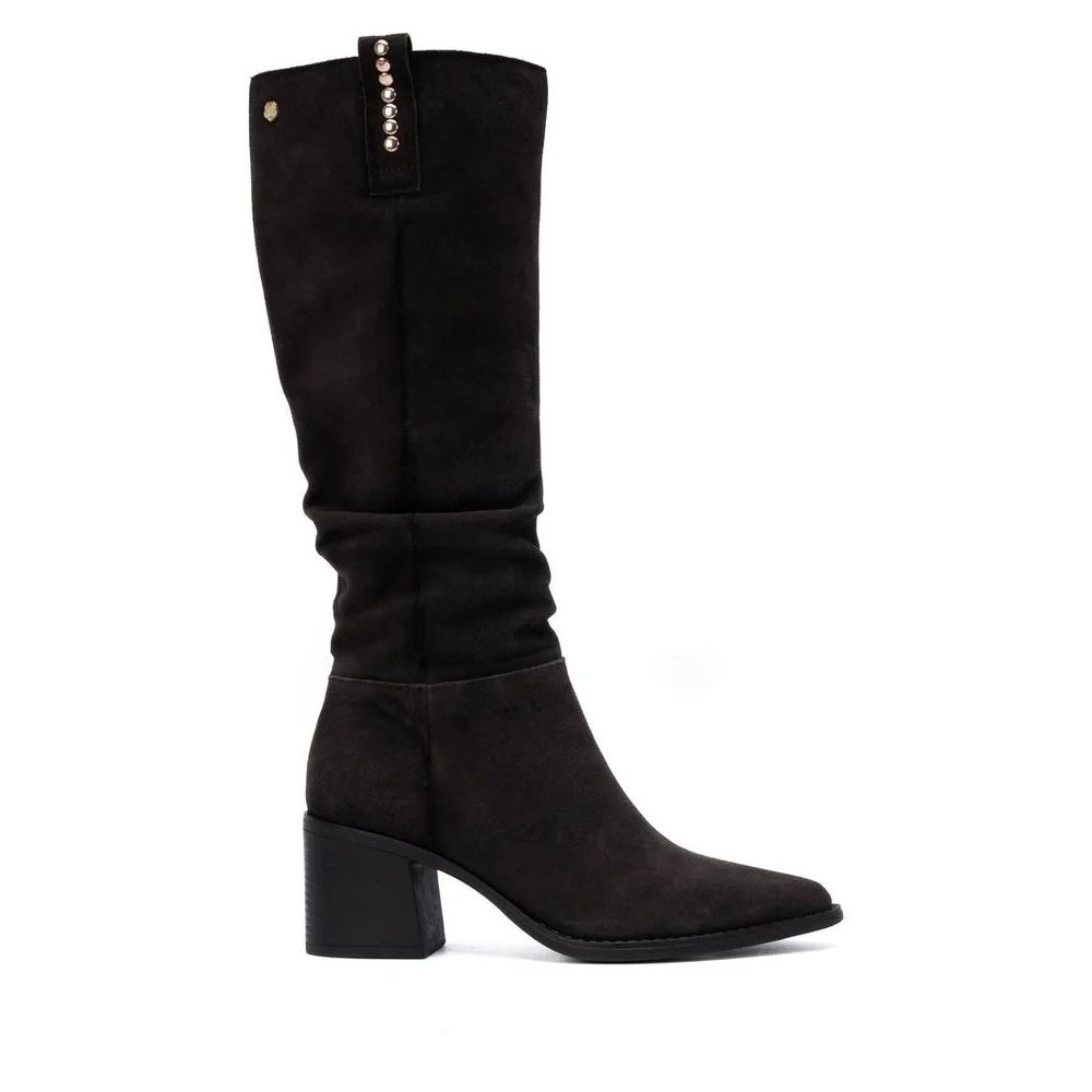 A Carmela Brown suede knee-high boot with a pointed toe and a block heel, featuring a decorative row of gold-tone studs along the inner shaft.
