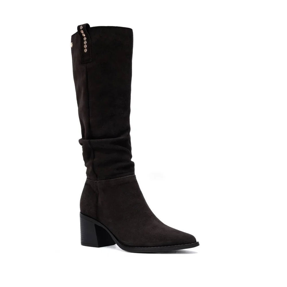 A Carmela dark brown suede knee-high boot with a block heel and a decorative row of silver studs along the inner shaft, shown against a plain white background.