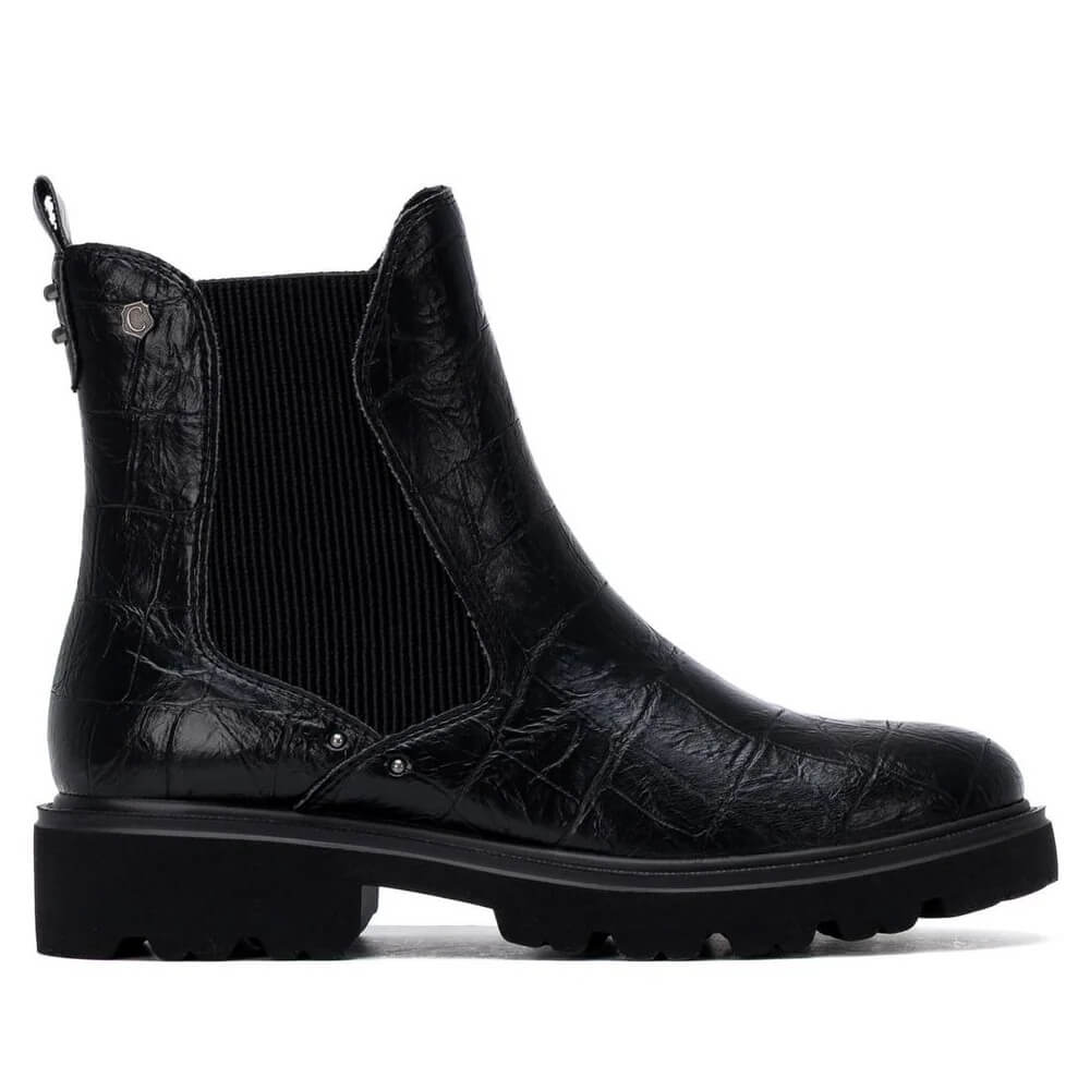 A Carmela single black ankle boot with a textured crocodile-embossed leather upper, a black ribbed elastic side panel, and a chunky lug sole, shown from a side profile on a white background.