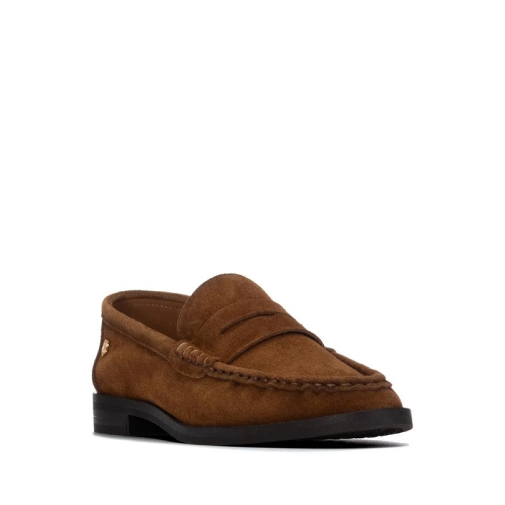 A Carmela brown suede penny loafer shown from a side profile view against a solid white background.
