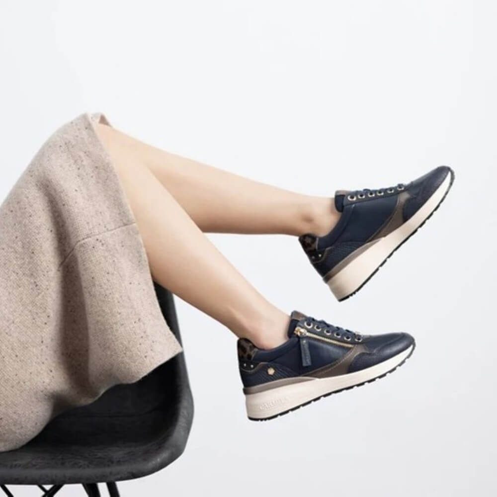 Navy blue sneaker with gold accents on a white background Carmela Leather Trainer 162442-NAVY