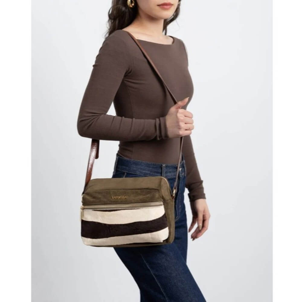 Woman holding a striped crossbody bag with a plain background Carmela Shoulder Bag 186186 Khaki Animal Print