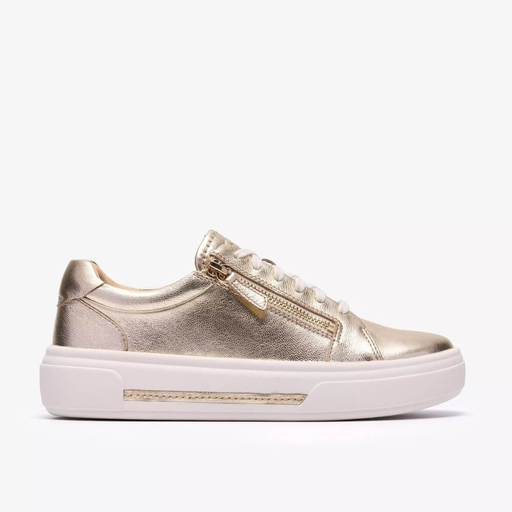 Clarks Gold sneaker with white sole on a white background