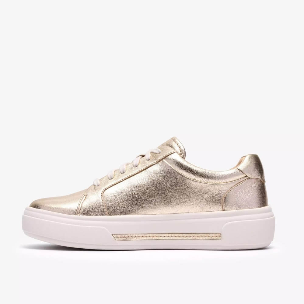 Clarks Gold sneaker with white sole on a white background