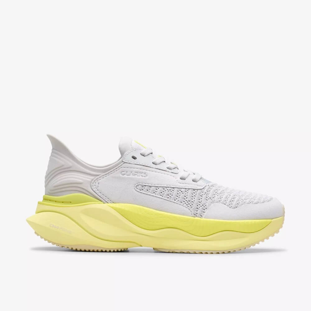 Clarks White Walking shoe with a yellow sole on a white background