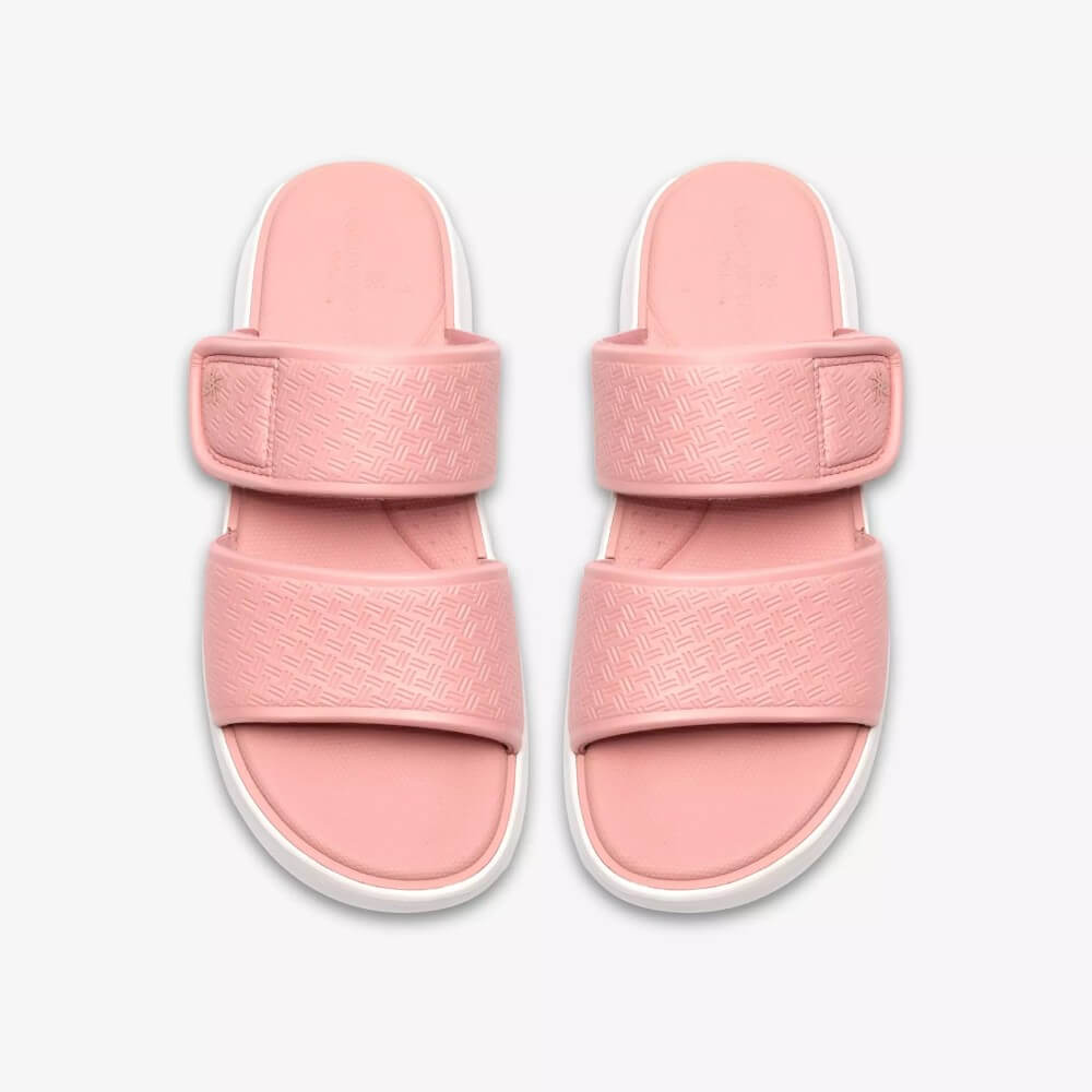 Clarks Pink slide sandals with white soles on a light Grey background