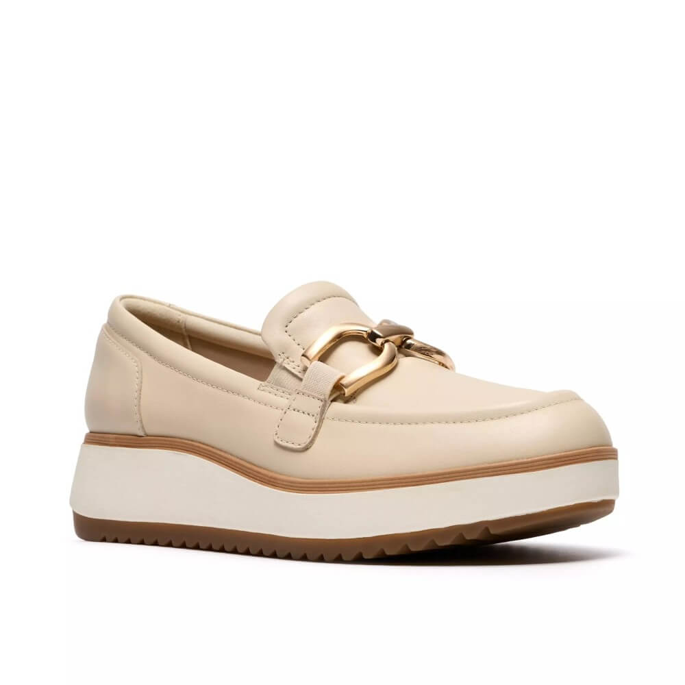 Clarks Beige loafer shoe with a gold buckle on a white background