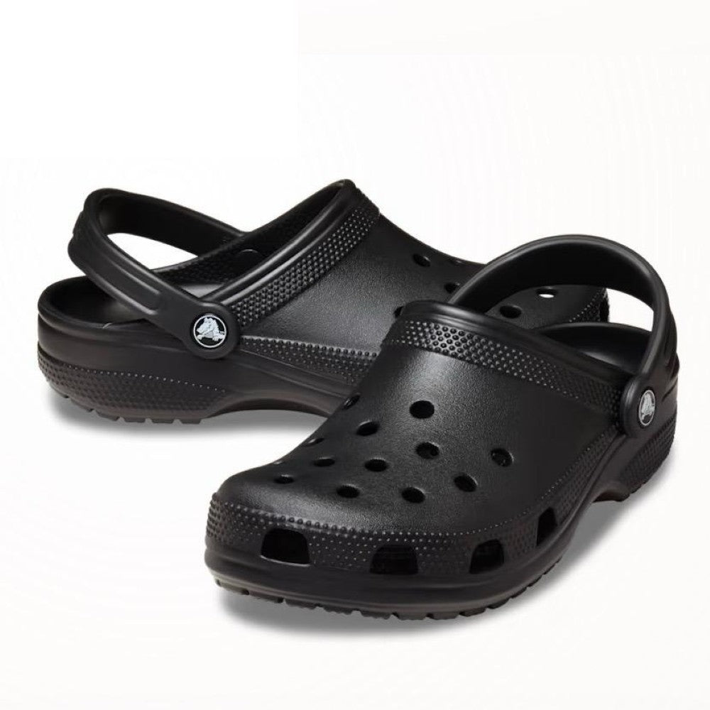 Black Crocs clog shoe on a white background