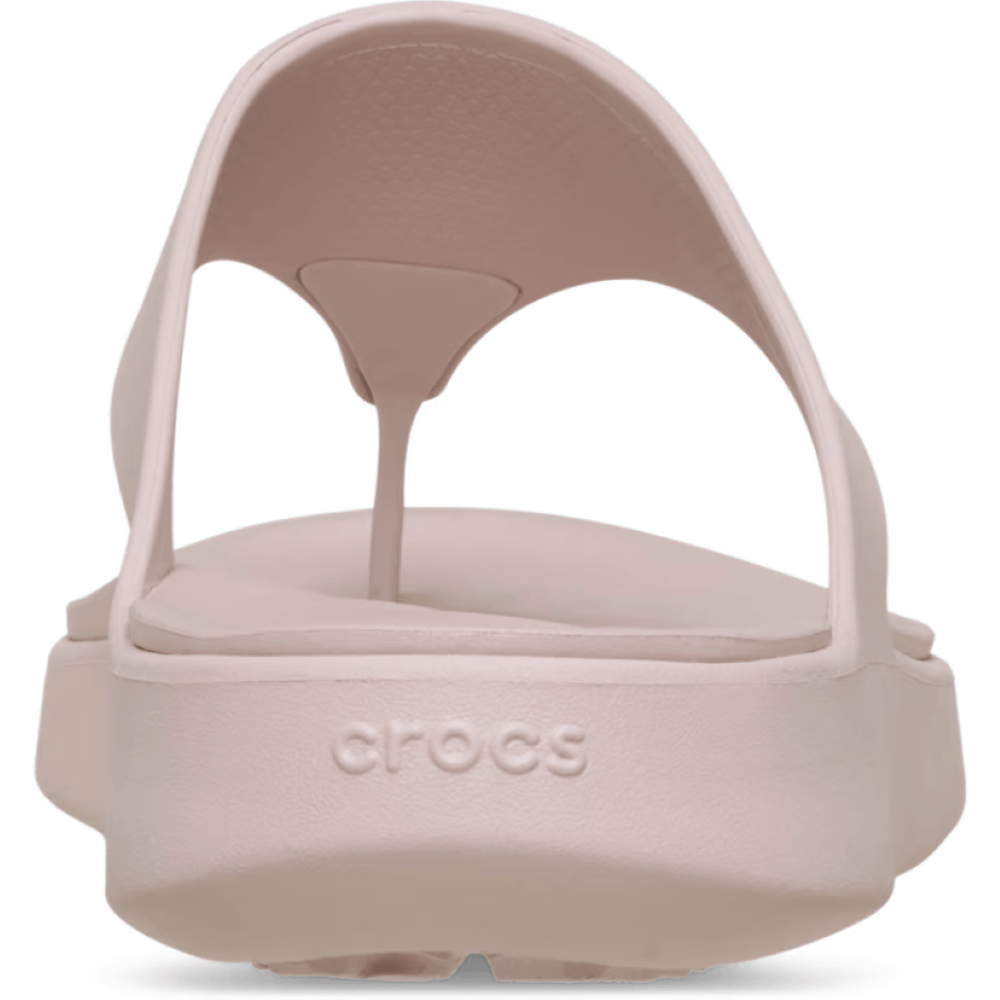 Pink sandal with 'crocs' branding on a white background