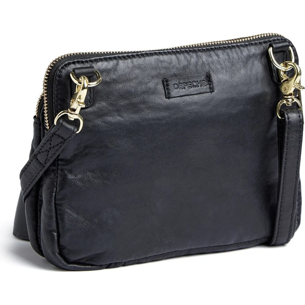 A black leather crossbody bag with gold-tone hardware, a top zipper, and a small 'Depeche' brand patch on the front, shown on a white background.