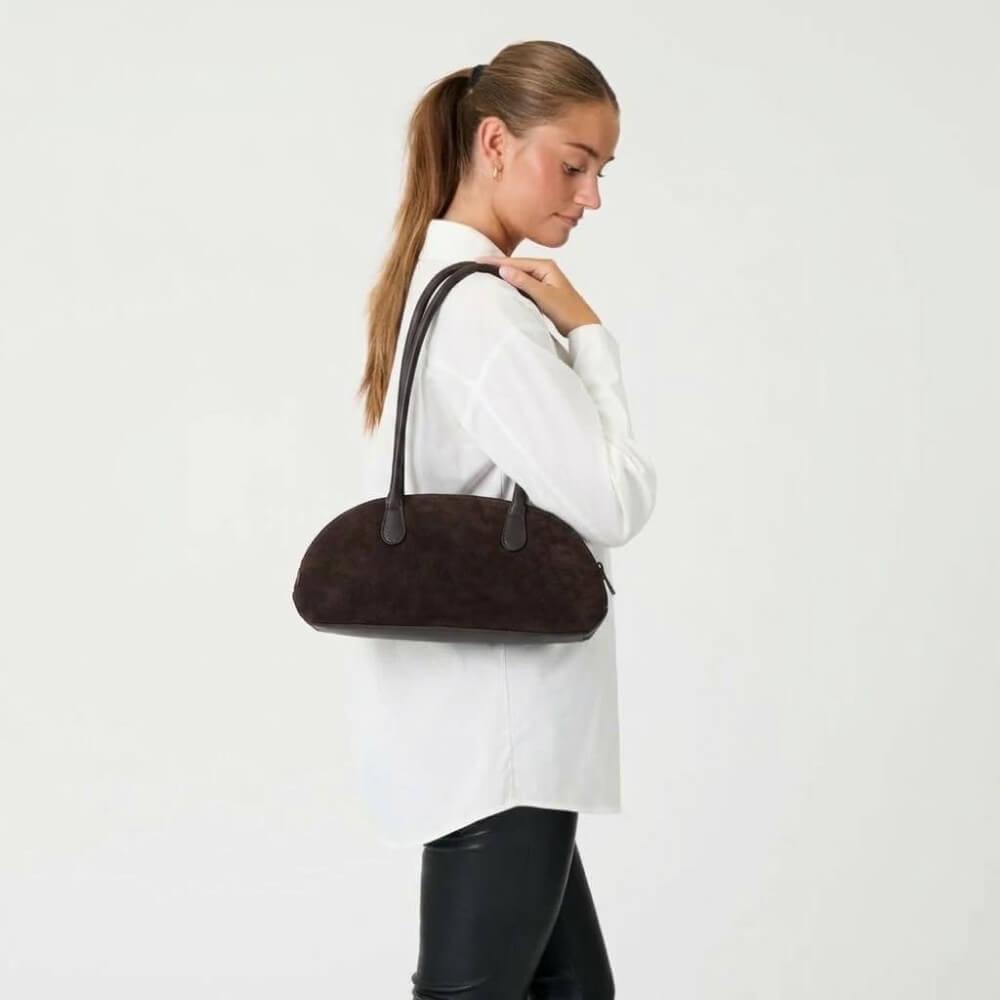 Person wearing a white shirt carrying a Depeche Dark Brown Suede Shoulder Bag on a white Background