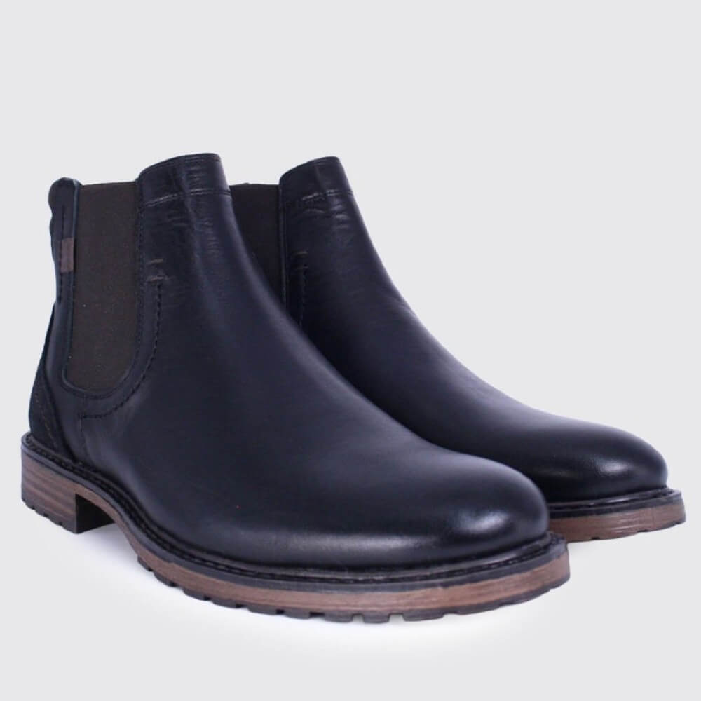 A pair of Dubarry lack leather Chelsea boots with elastic side panels and brown soles, photographed on a light grey background.