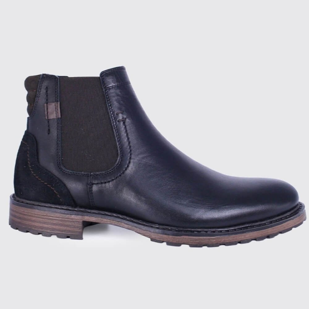 A Dubarry black leather Chelsea boot with a dark elastic side panel and a brown stacked sole, shown in a side profile on a light grey background.