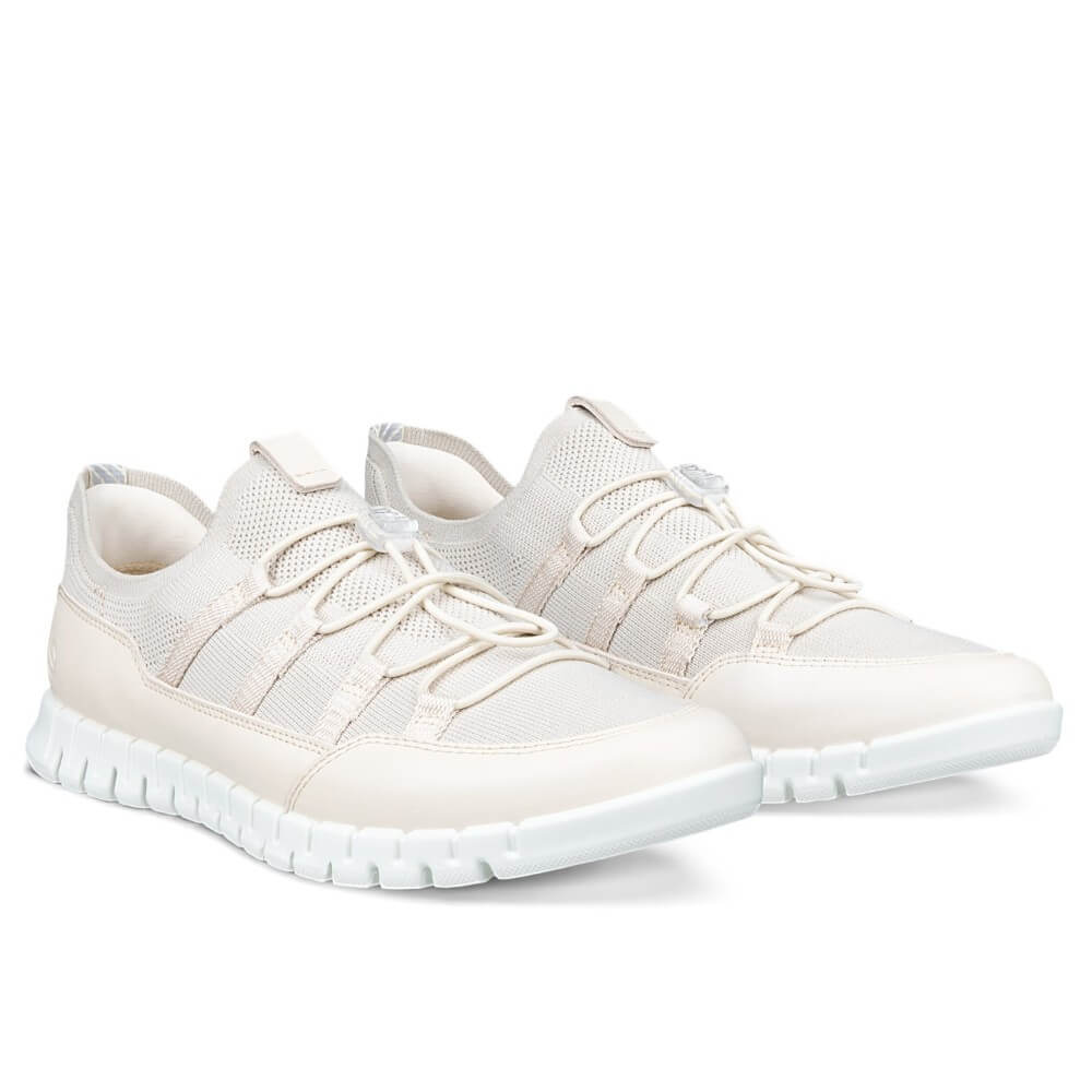 Pair of Ecco Beige sneakers with a white sole on a white background 