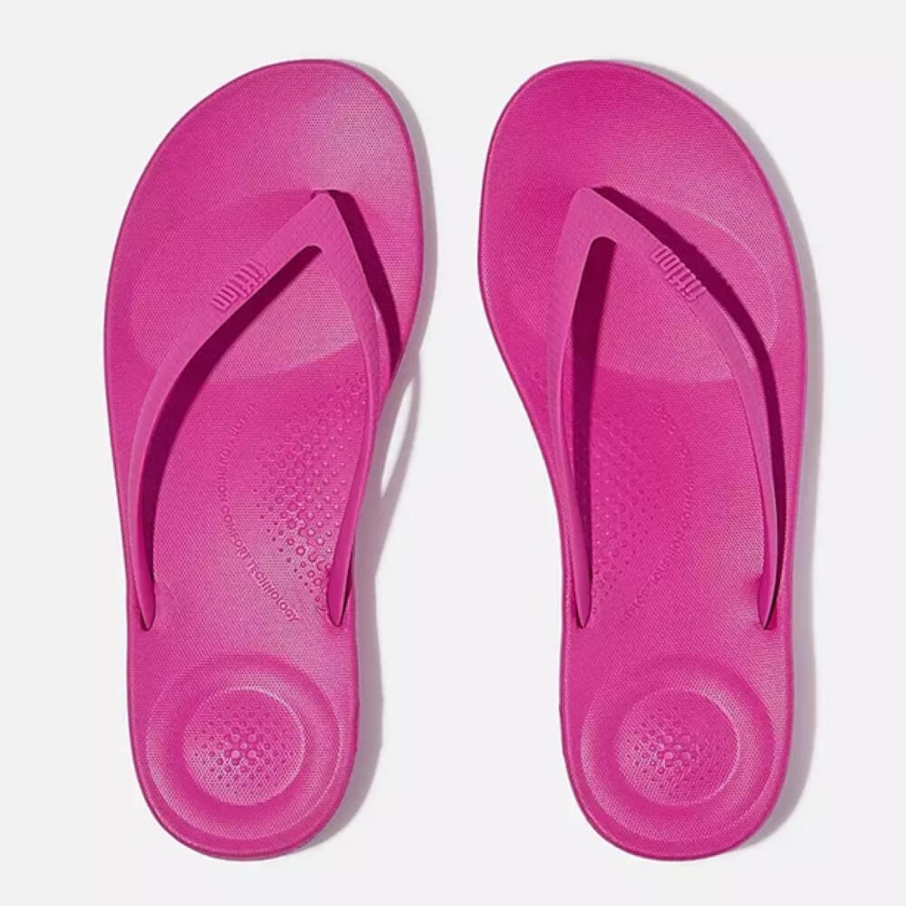 Pair of pink flip-flops on a white background