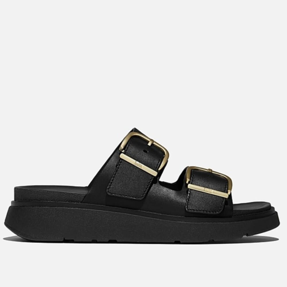fitflop Black sandal with gold buckles on a white background