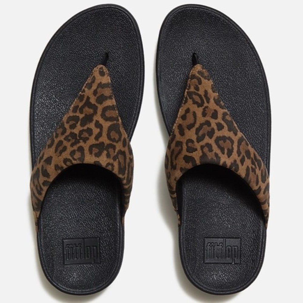 Pair of leopard print sandals with black soles on a white background