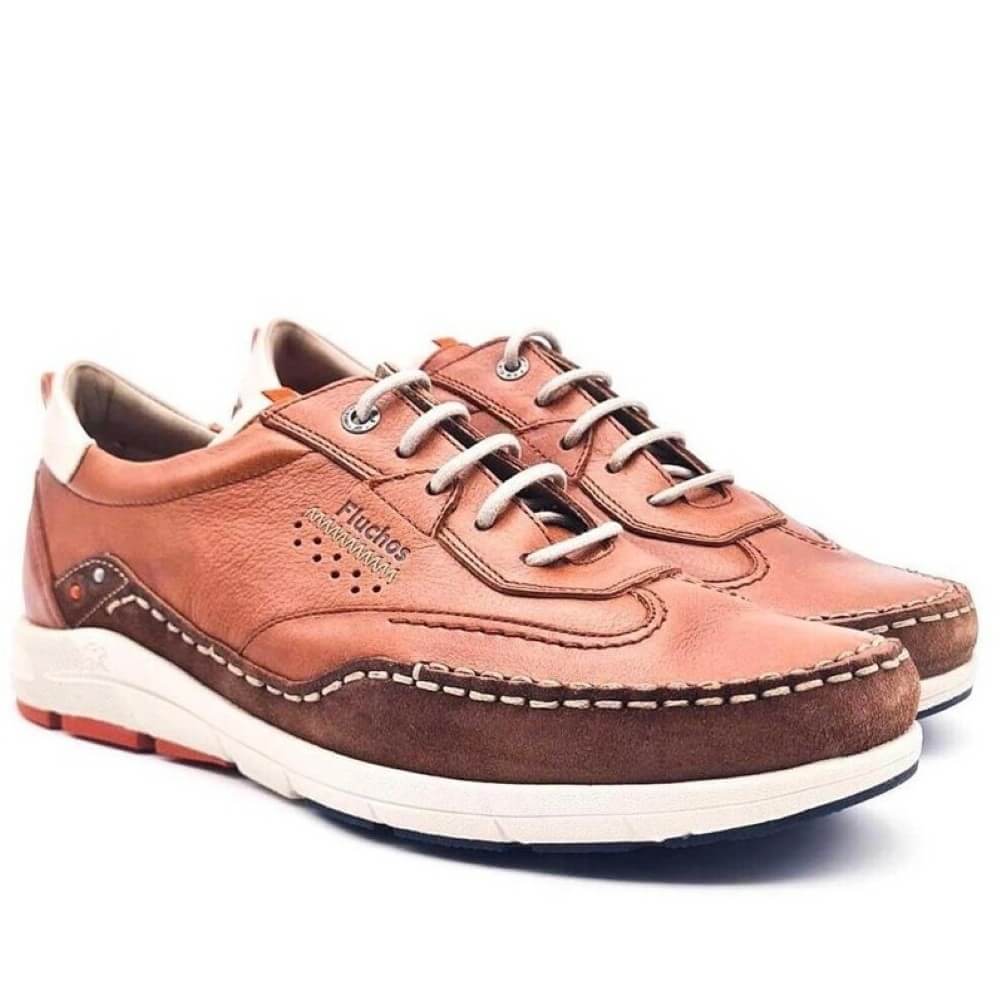 Fluchos Brown leather shoes with white soles on a white background