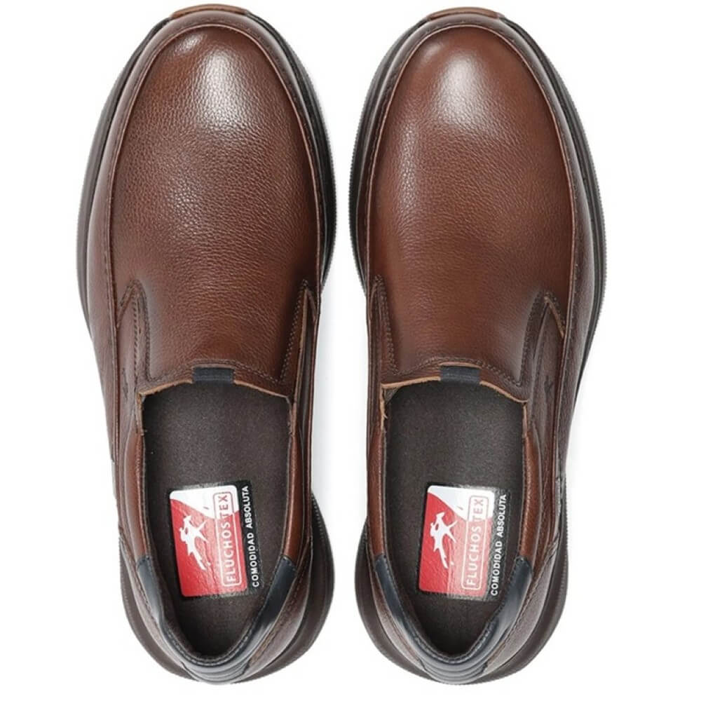 Brown slip-on shoe with black sole on a white background, featuring a waterproof label. Fluchos Triton F2064 Waterproof Leather Slip-on Nut Brown