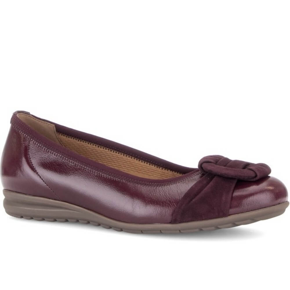 Gabor flat shoe in a deep burgundy leather, featuring a decorative knotted suede detail on the toe box and a low, flexible sole, shown against a plain white background.