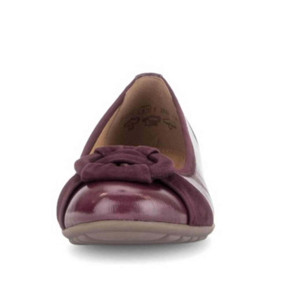 Gabor flat shoe in a deep burgundy leather, featuring a decorative knotted suede detail on the toe box and a low, flexible sole, shown against a plain white background.