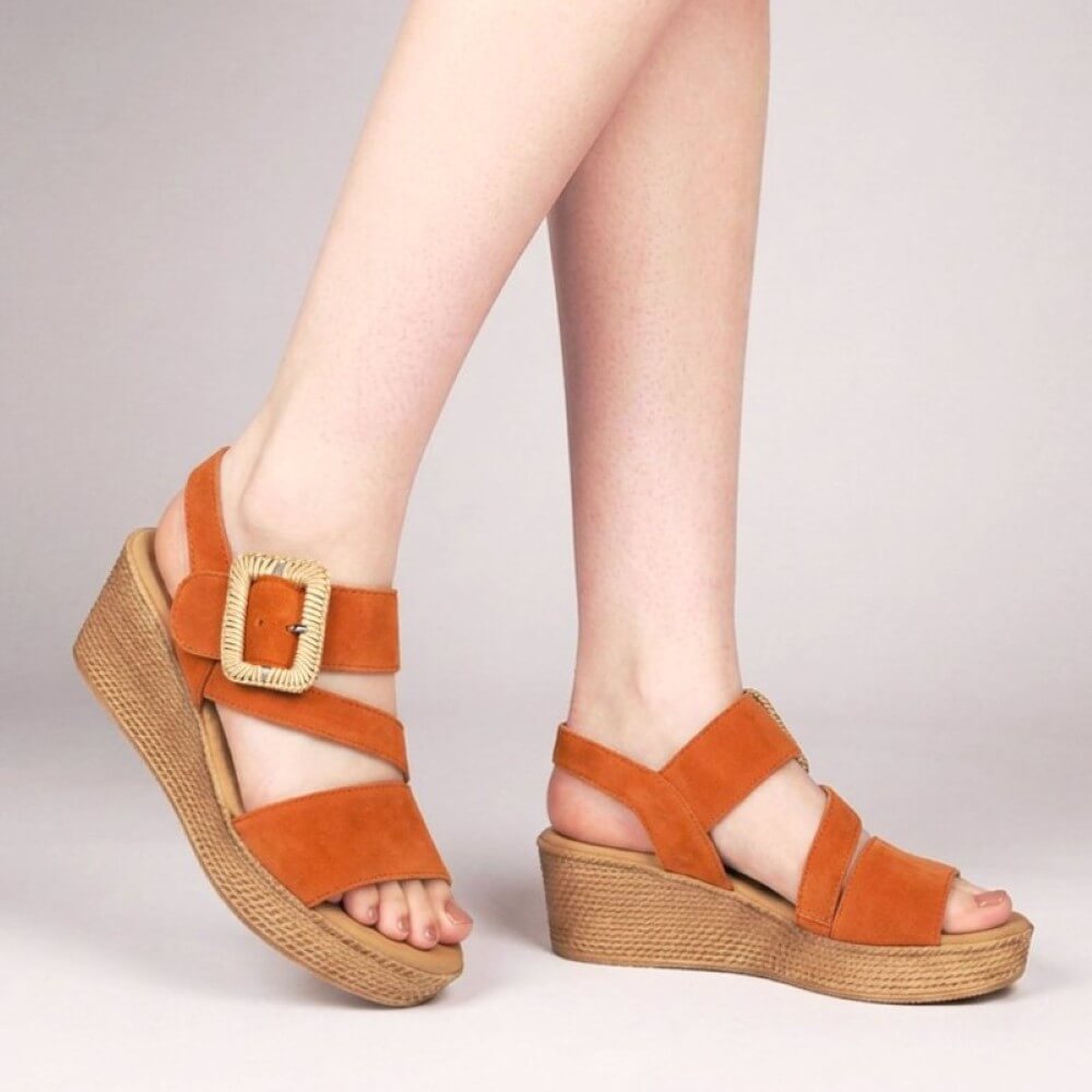 Gabor Orange sandals with woven soles worn by a person on a light gray background