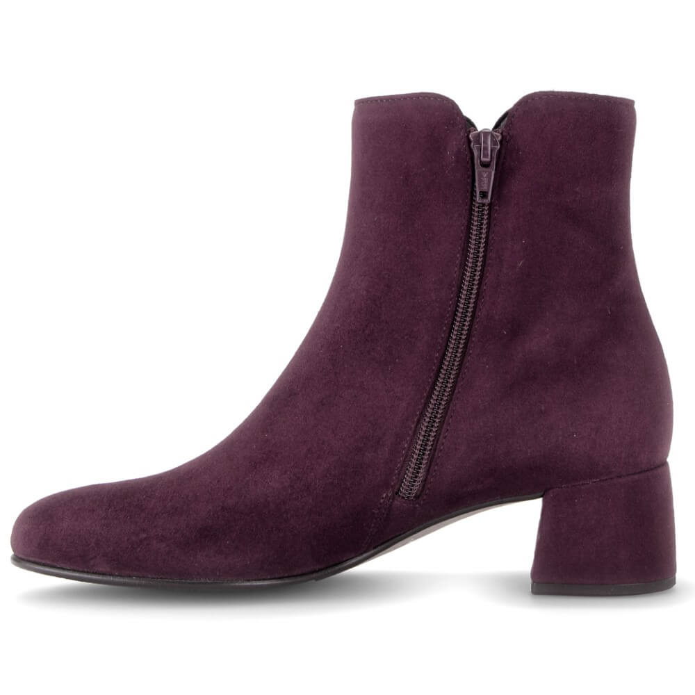 A Gabor dark purple suede ankle boot with a low block heel and a side zipper, shown from a side profile on a white background.