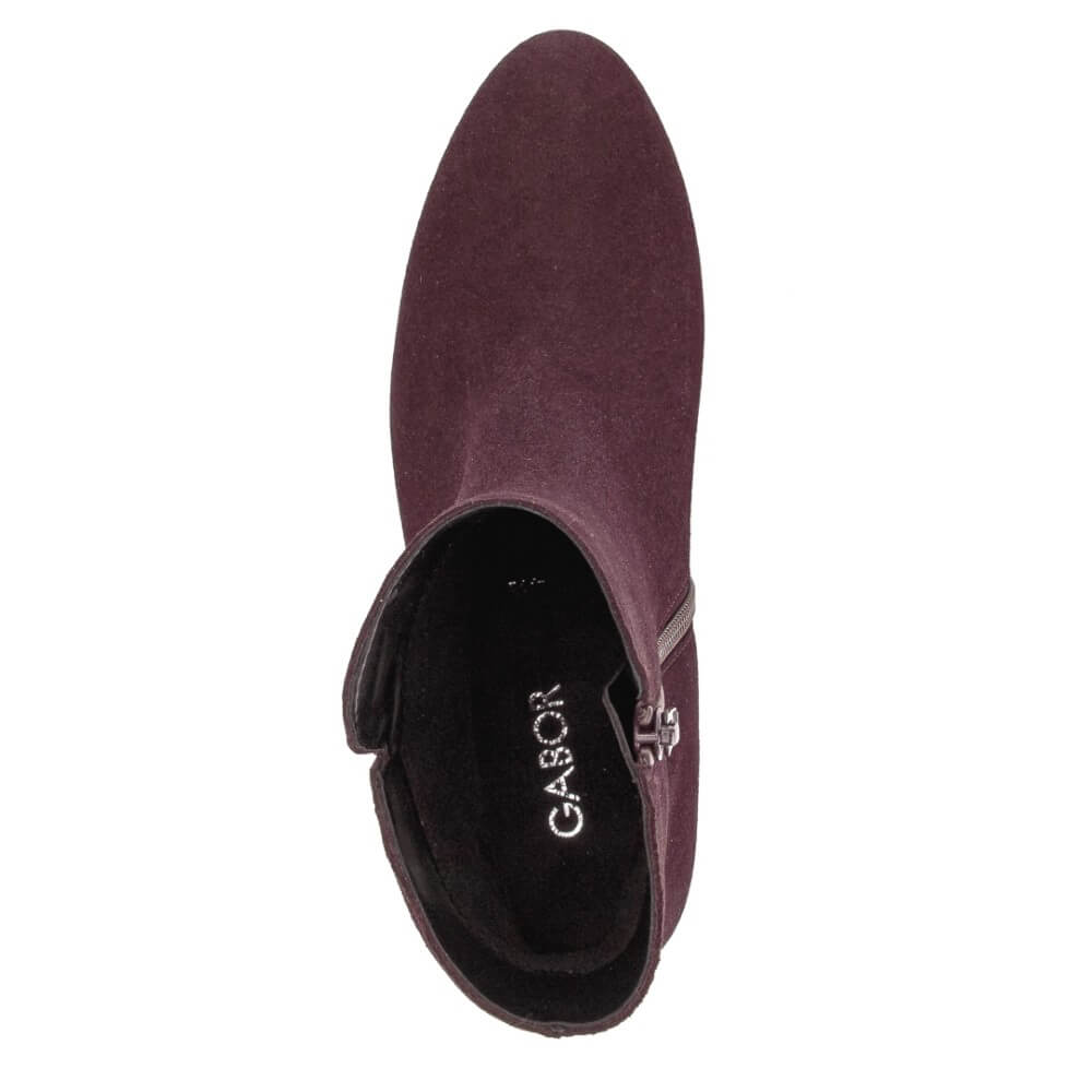 A single dark plum purple suede ankle boot shown from a top-down view on a white background, featuring a side zipper and the brand name 'GABOR' printed on the black interior.