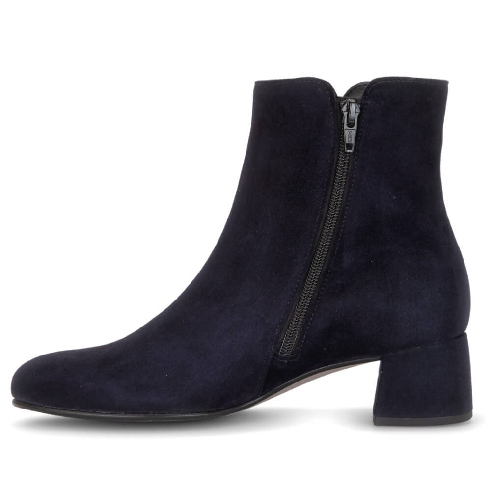 A Gabor navy blue suede ankle boot with a low block heel and a side zipper, shown from a side profile view on a white background.