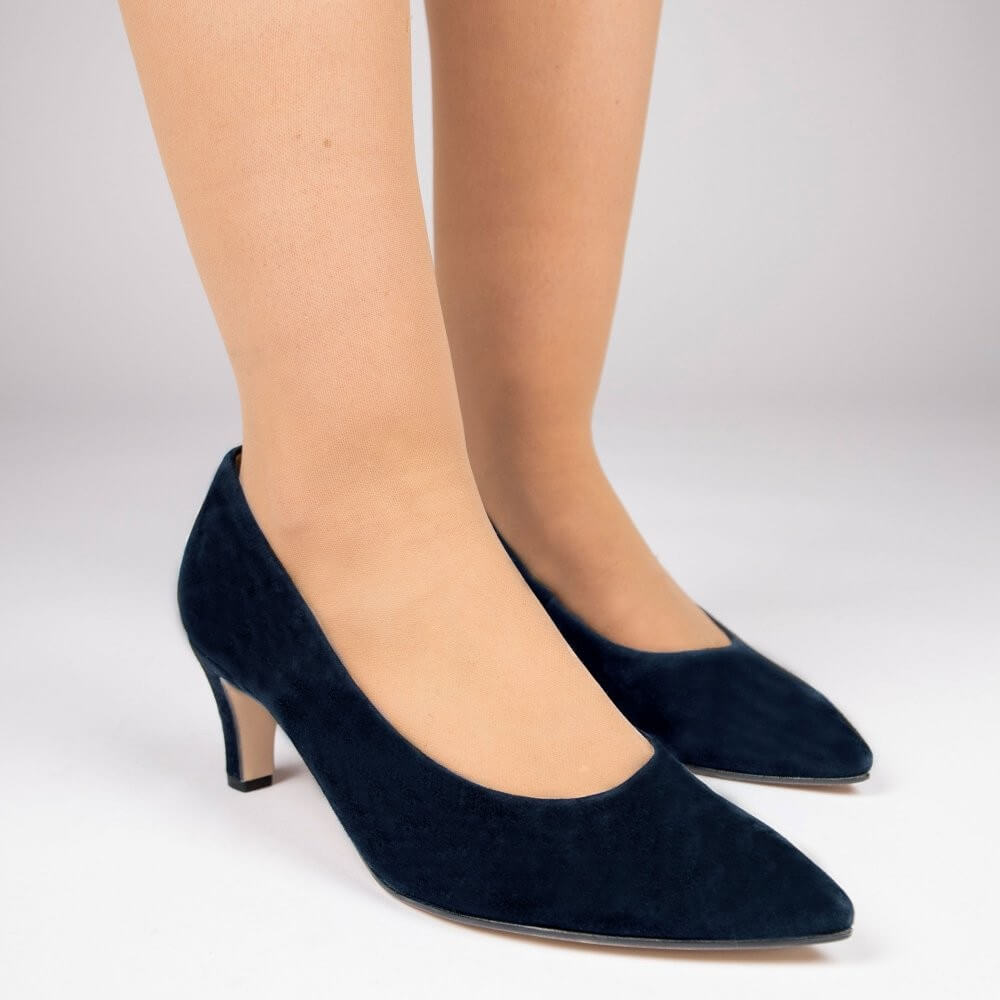 A pair of Gabor navy blue suede pointed-toe pumps with kitten heels, shown on a model's feet against a light gray studio background.