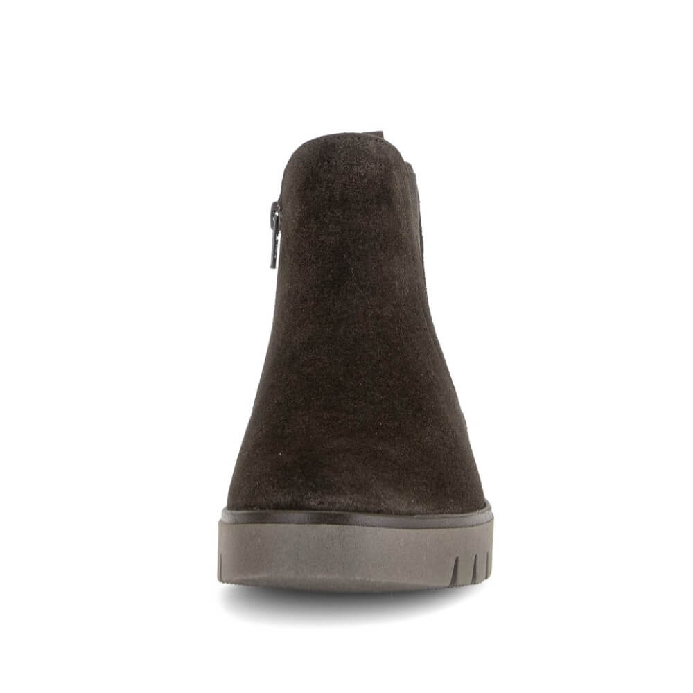A single dark brown suede ankle boot shown from the front, featuring a side zipper and a thick grey sole, set against a plain white background.
