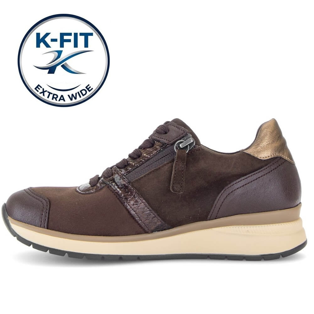 A Gabor dark brown K-FIT extra wide sneaker with a side zipper, brown laces, and a beige midsole, shown from a side profile on a white background with a K-FIT logo overlay in the top left.