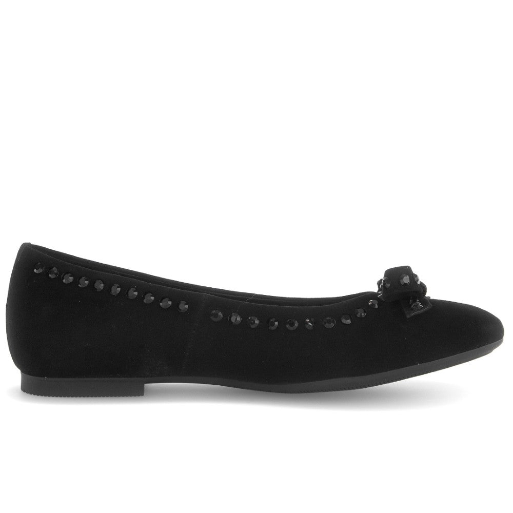 Black flat shoe with decorative elements on a white background