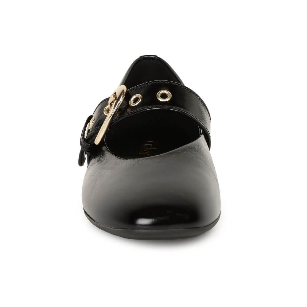 Black shoe with gold buckle on a white background