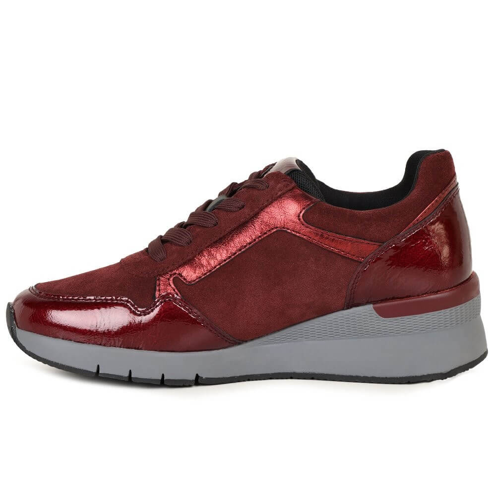 Red sneaker with a gray sole on a white background