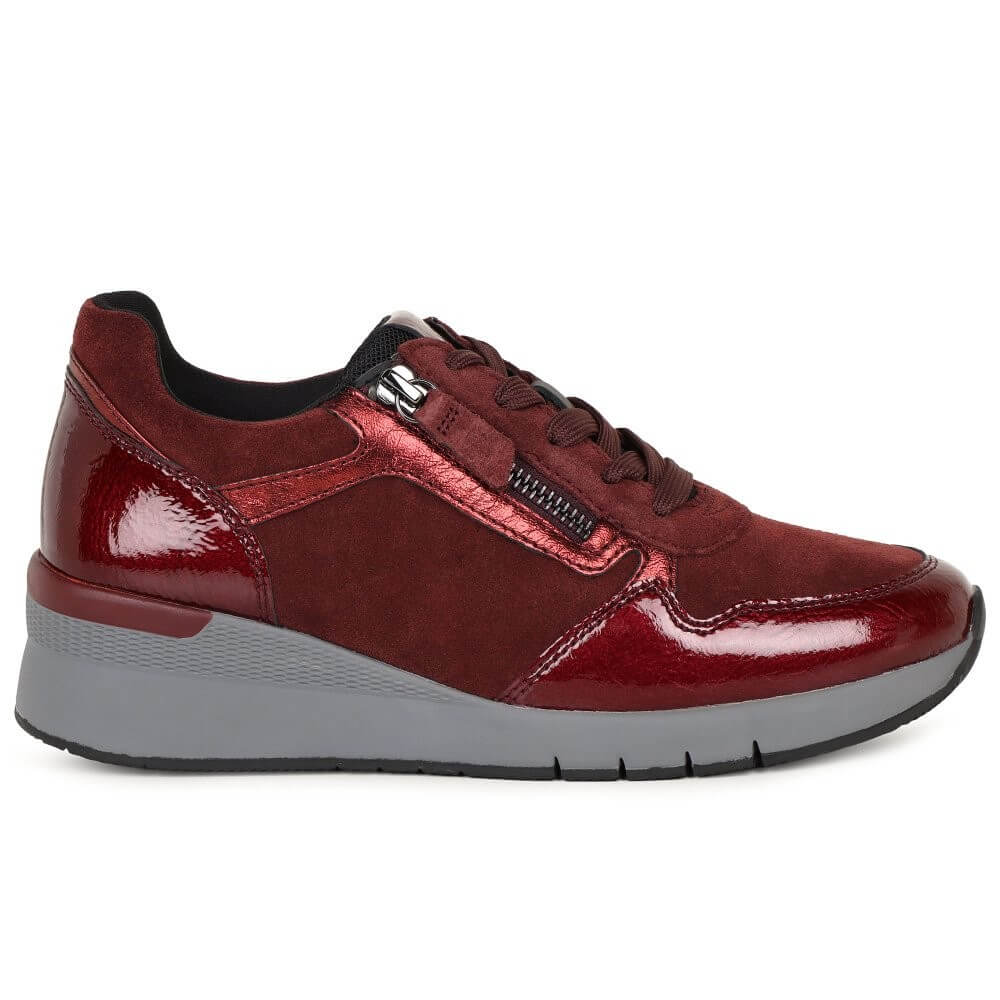 Red sneaker with a gray sole on a white background