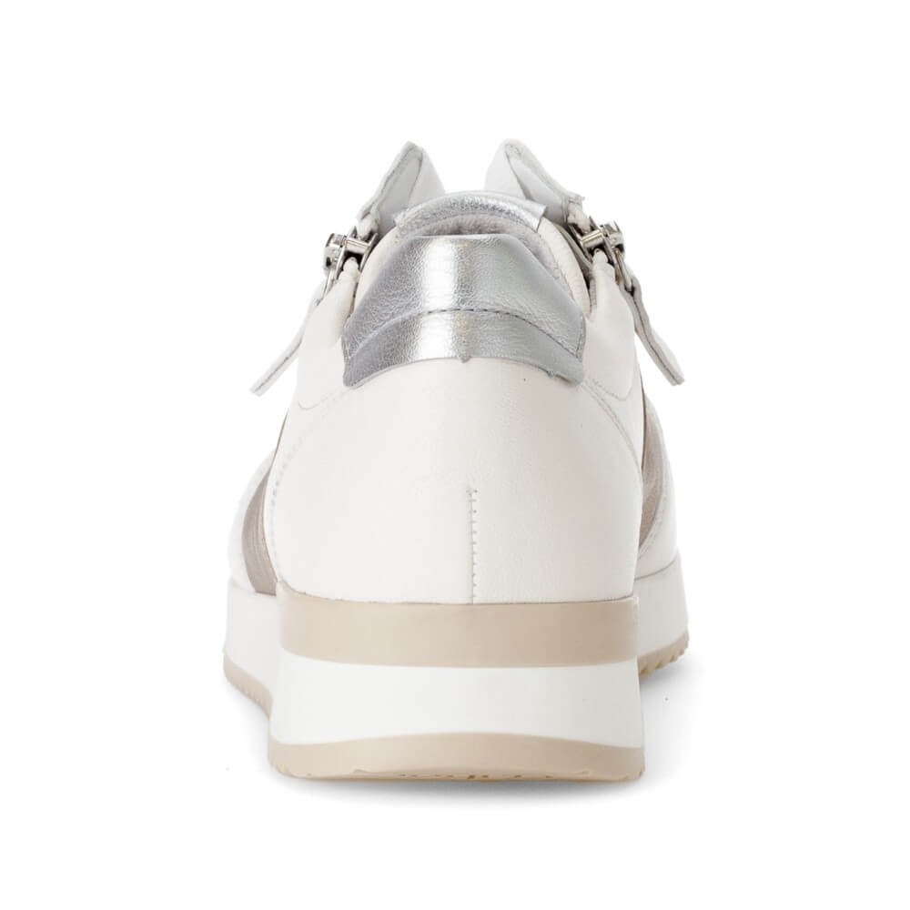 White sneaker with silver accents on a white background
