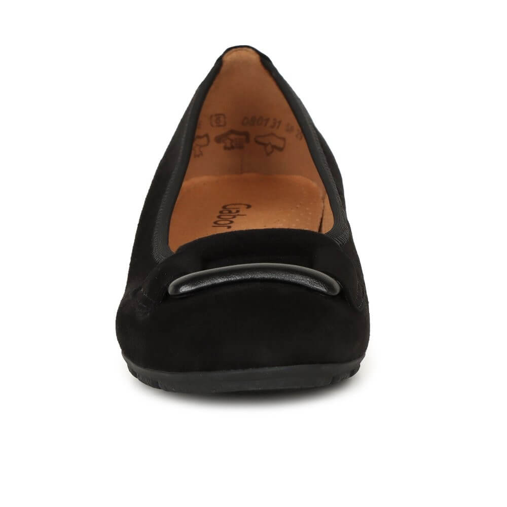 Black flat shoe with a detail on a white background
